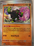 Okidogi - 057/131 - Holo - PRISMATIC EVOLUTIONS - Pokemon - Rare | AA30-9