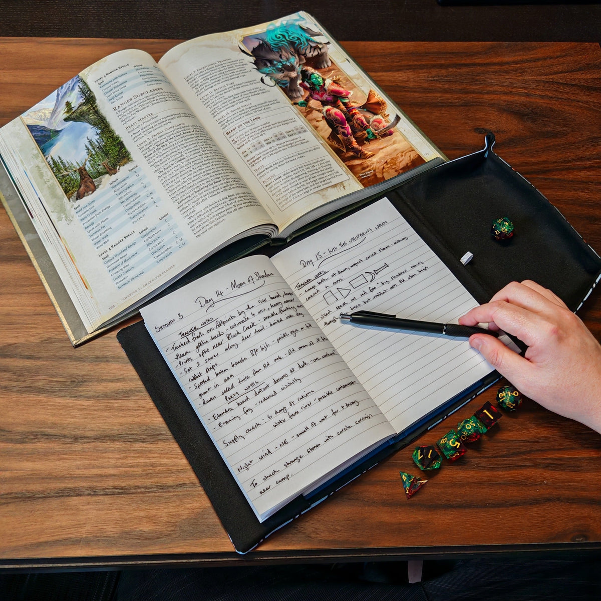 RPG game notes in an A5 notebook with pen, tabletop dice and a game book